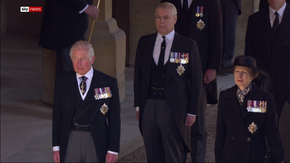 Prince Charles and Prince Andrew walk with Princess Anne behind their father's casket