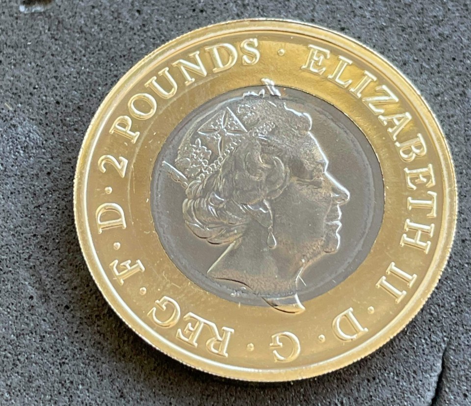 The Queen's head bleeds into the outer yellow ring on the error coin