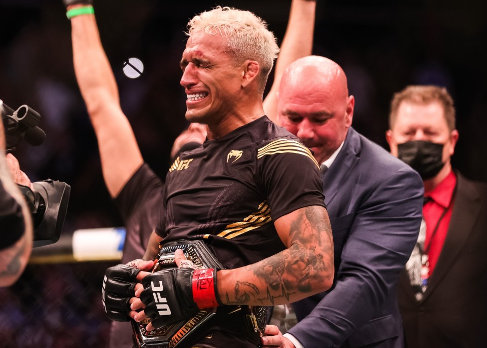 Charles Oliveira is overcome with emotion after Dana White wraps the UFC lightweight title around his waist