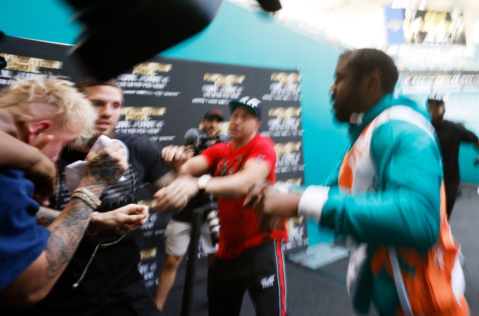 Jake Paul covers up during Floyd Mayweather brawl