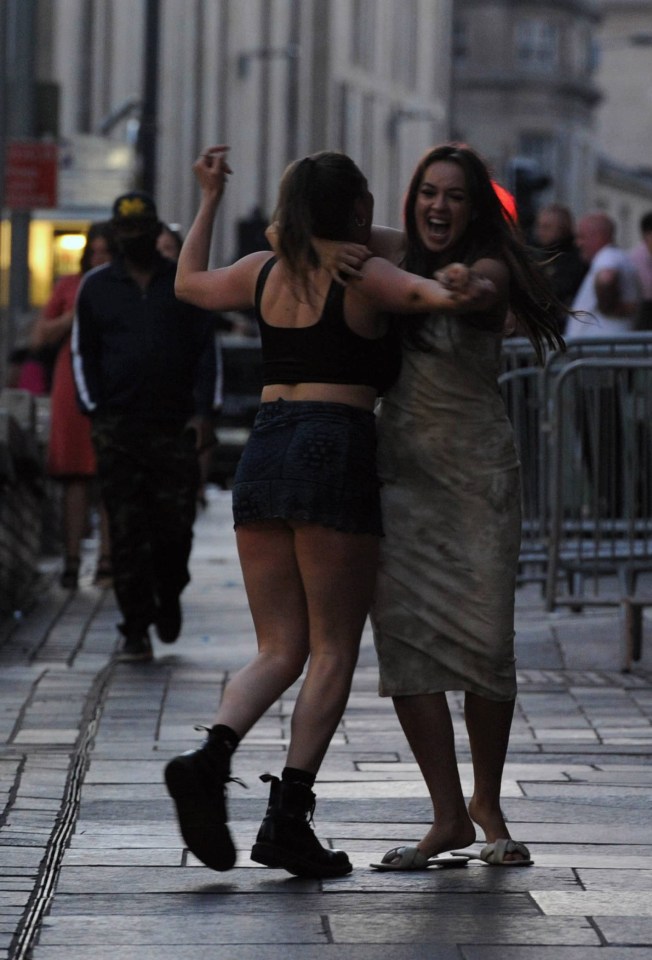 Two girls embraced during a boozy evening