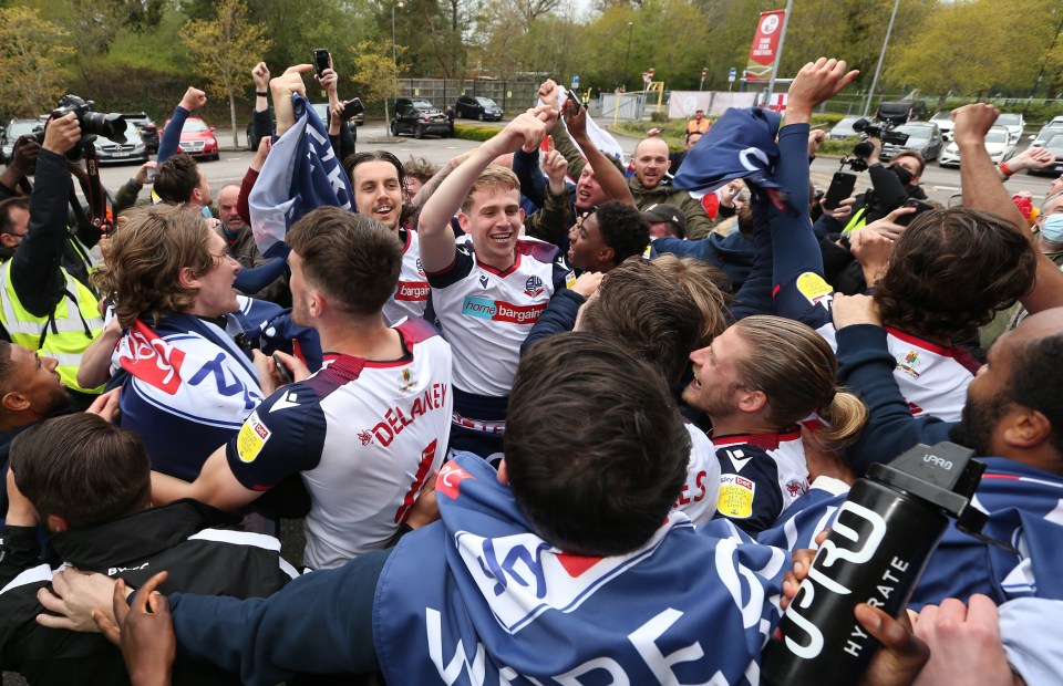 Bolton players celebrate outside the ground on Saturday