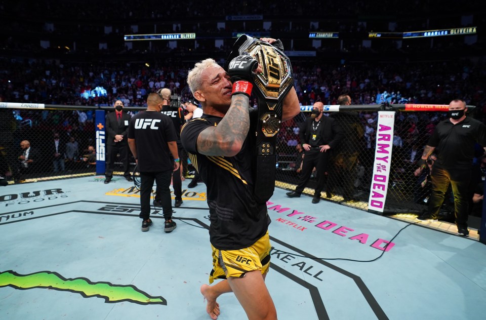 An emotional Oliveira parades around with his belt