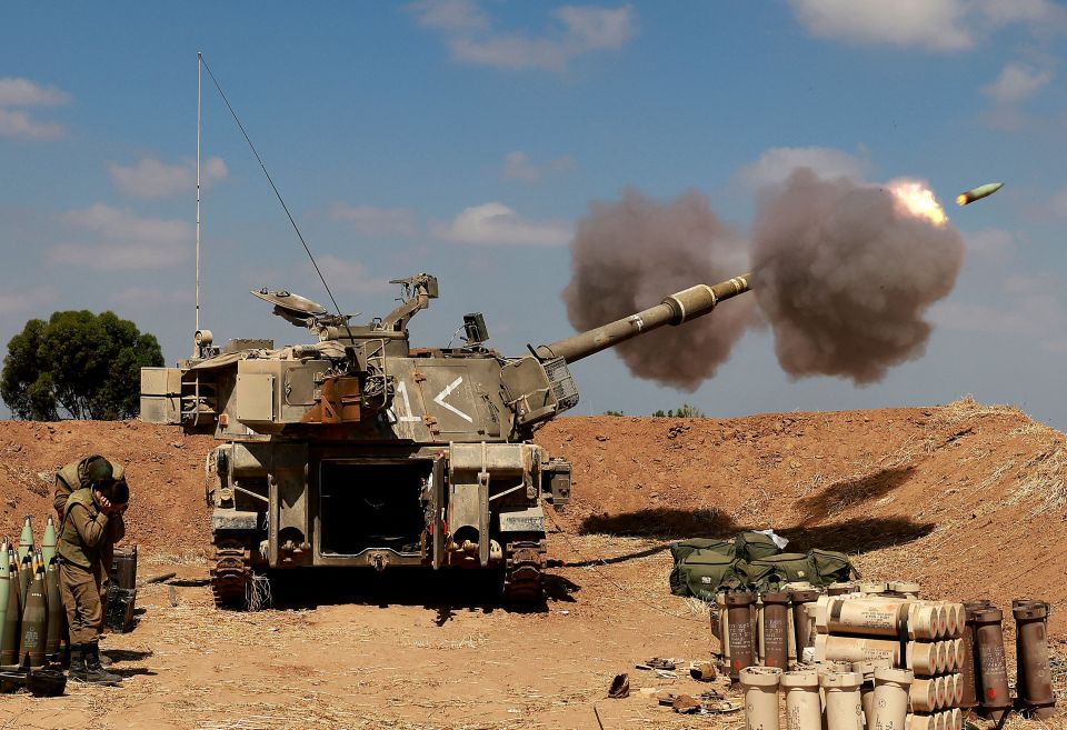 An Israeli tank fires towards the Gaza Strip