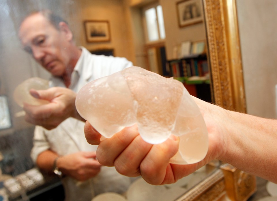 Plastic surgeon Denis Boucq holds a defective PIP silicone gel breast implant