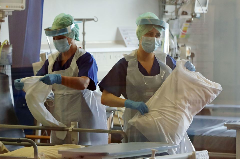 Nurses change bed clothes at the Mater Hospital Covid-19 recovery ward in Belfast