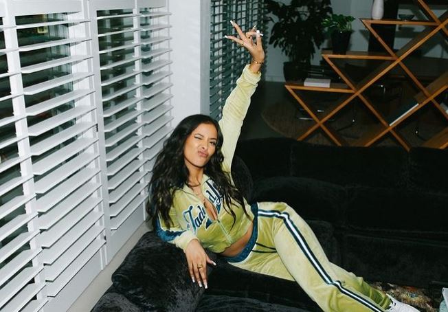 Maya Jama posing in her green tracksuit in a now-deleted pic