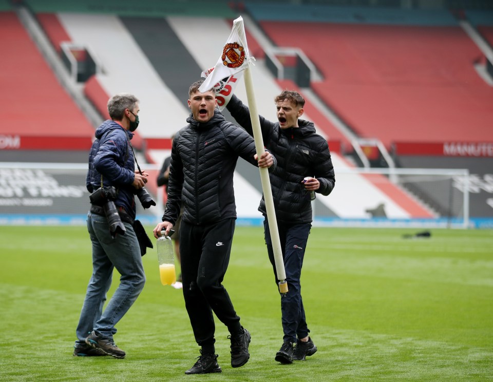 One protestor commandeered the corner flag as the pitch invasion went on