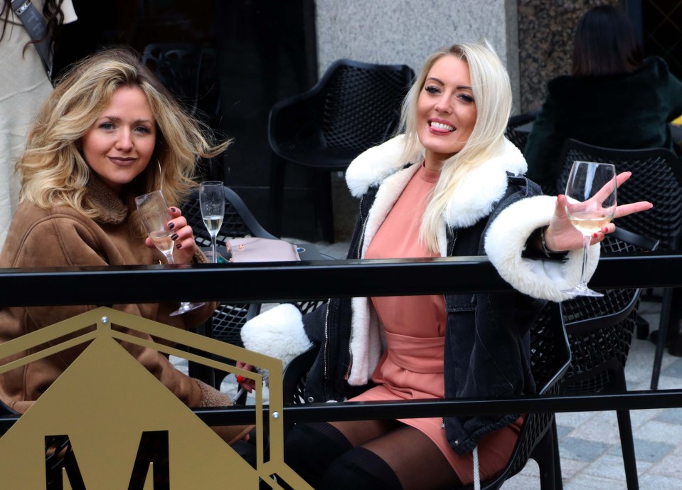 Women posed as they enjoyed a glass of bubbly at an al fresco bar