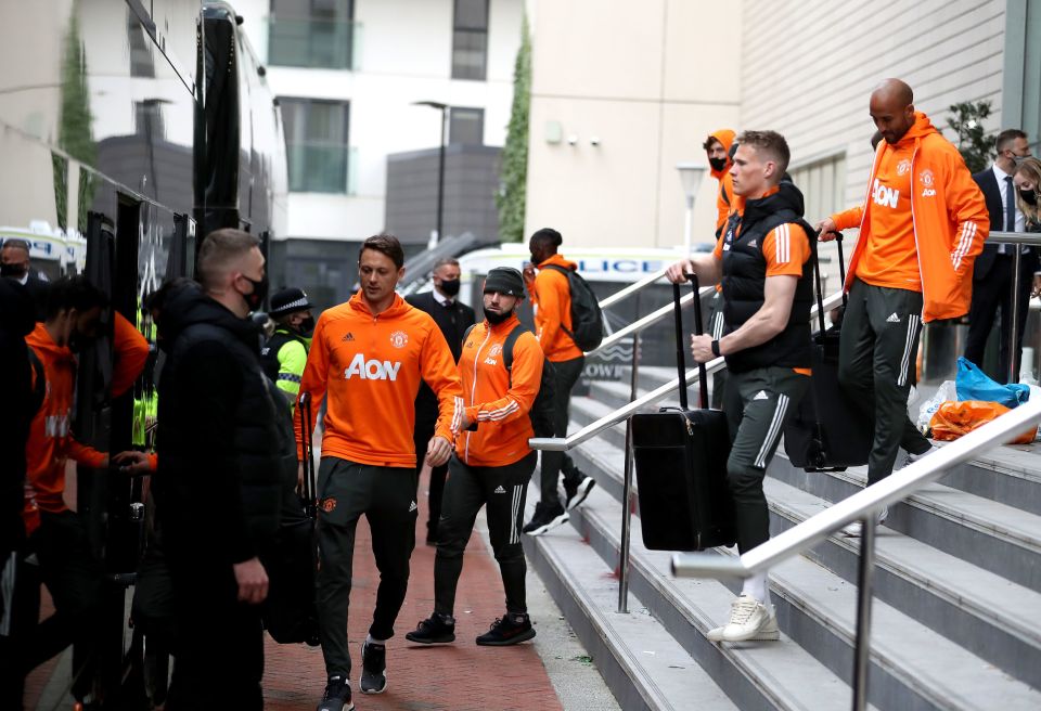 The players take their luggage onto the team coach