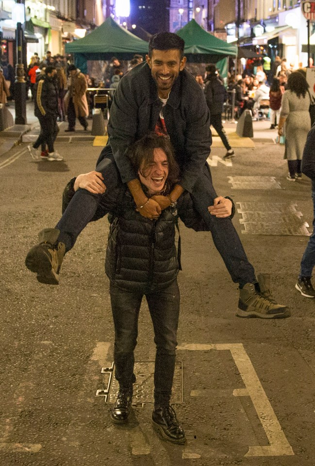 Two revellers enjoying a night out in Soho, London