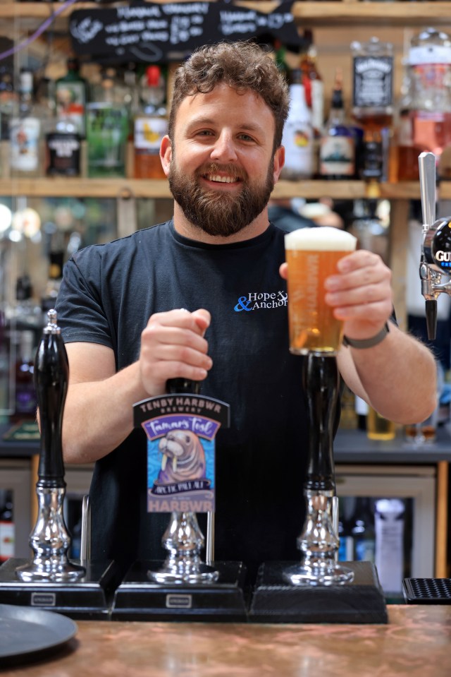 Brewer Rob Luly pulls a pint of Tamar's Tusk, a special beer dedicated to Wally