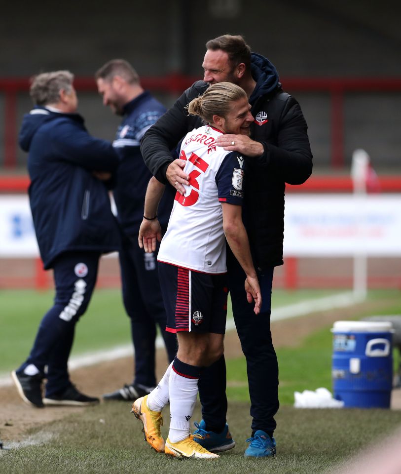 Boss Ian Evatt, hugging Lloyd Isgrove, wants to see more Bolton shirts in the town