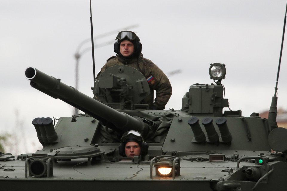 Servicemen are seen on a T-80BVM tank ahead of a military parade marking the 76th anniversary