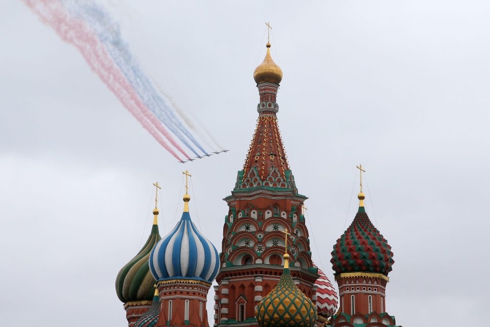 Sukhoi Su-25BM jet aircraft leave a trail in the Russian national colours as they fly over Moscow