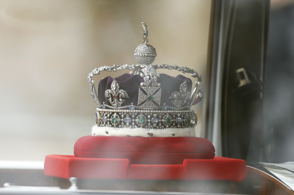 The Imperial State Crown is driven down The Mall on its way to the Houses of Parliament