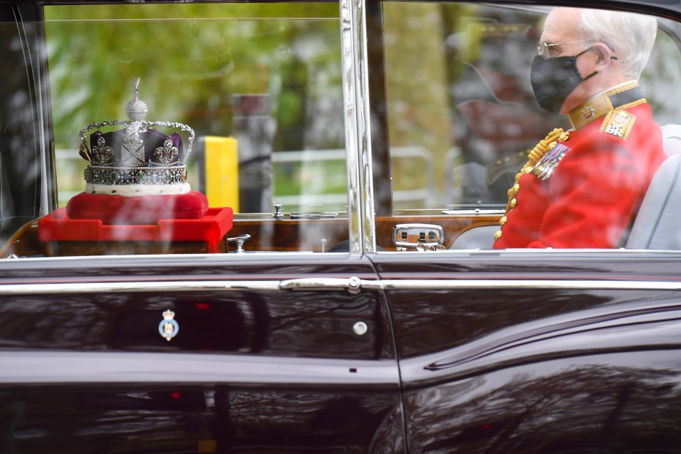 The crown being taken to Parliament - but is not worn by the Queen today