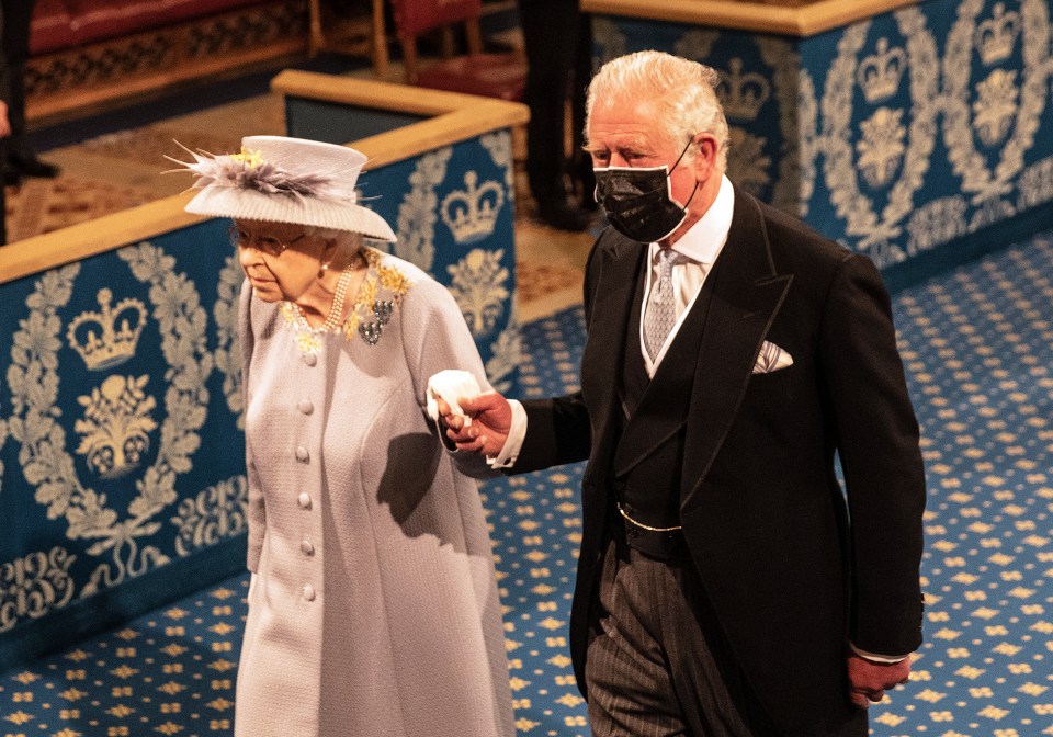 Prince Charles holds the Queen's hand as she entered for the ceremony