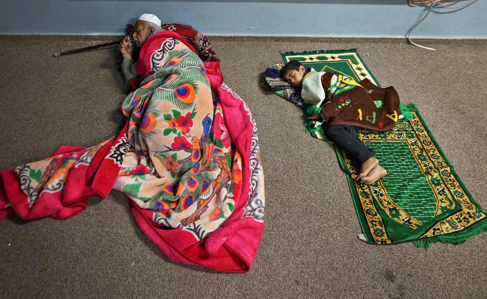 Palestinians sleep in a UN school in Gaza after fleeing from their homes in Beit Lahia