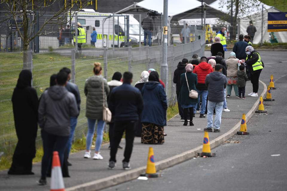 People in Bolton queue for a vaccine, with the area currently experiencing a spike in cases from the new Indian variant