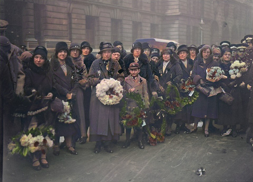 A war widow holds a wreath with the badge of the Coldstream Guards at the Field of Remembrance, Westminster