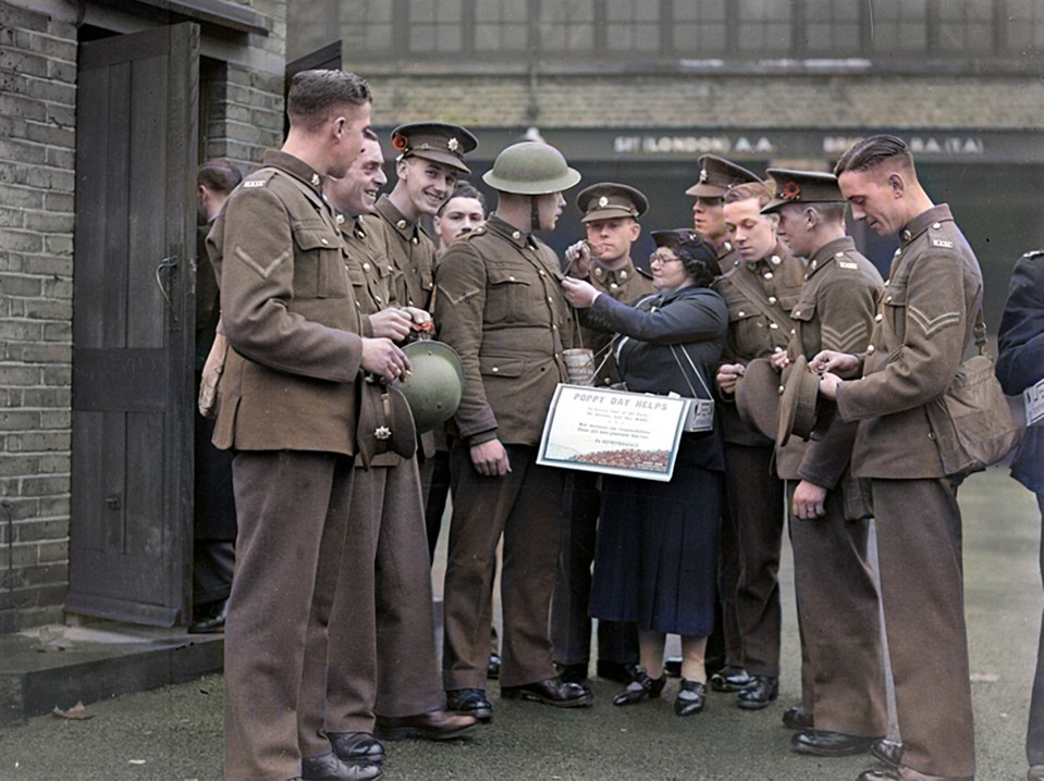 British troops fix their poppies to their uniforms on Armistice Day during the Second World War in 1939