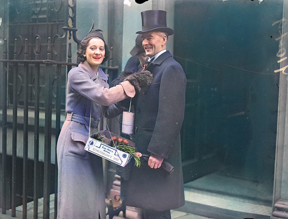 PM Neville Chamberlain buys a poppy on Armistice Day, 1937, outside Downing Street