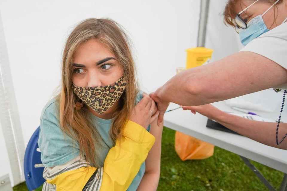 A woman being vaccinated in Bolton