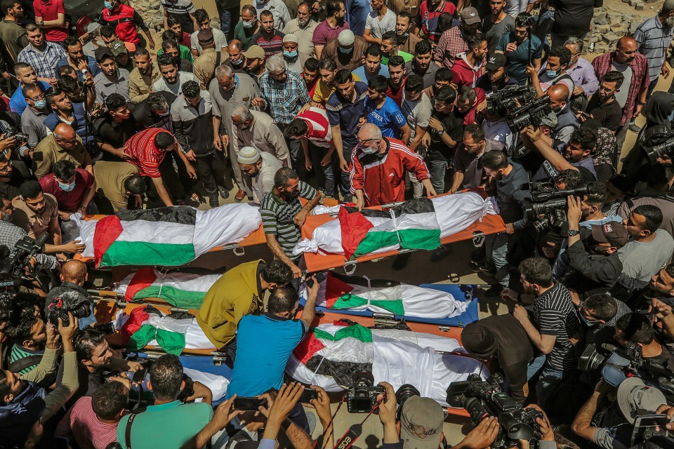 Palestinians attend the funeral of 10 members of the Abu-Hatab family in Gaza City