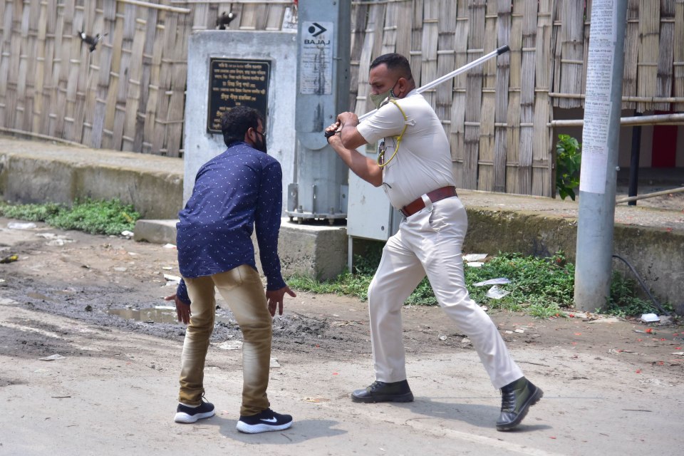 Police have been pictured hitting Covid rule breakers with sticks in Assam