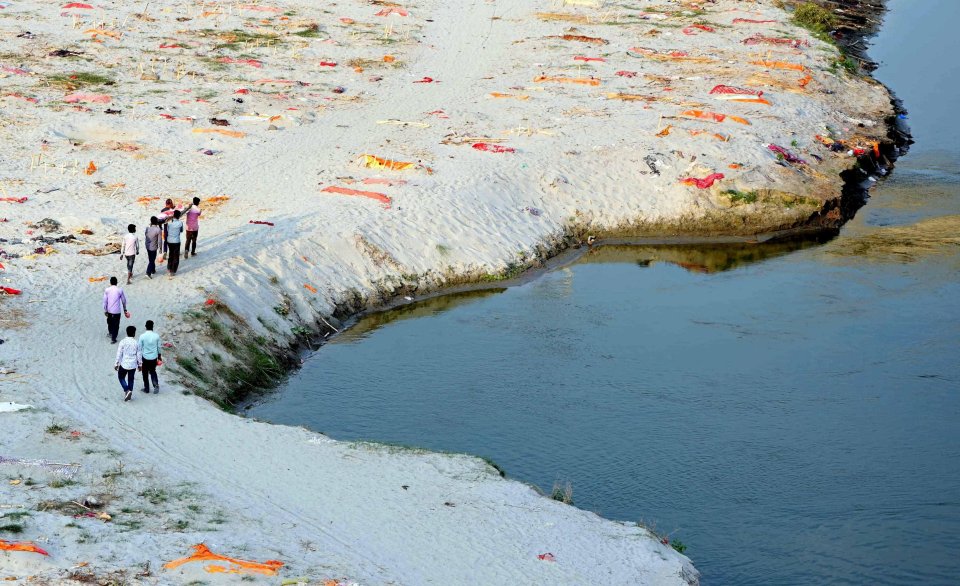 Bodies buried in shallow graves have washed up on the banks of the Ganges