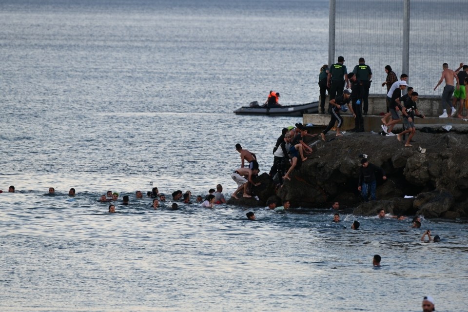 Migrants swimming to Ceuta on Monday