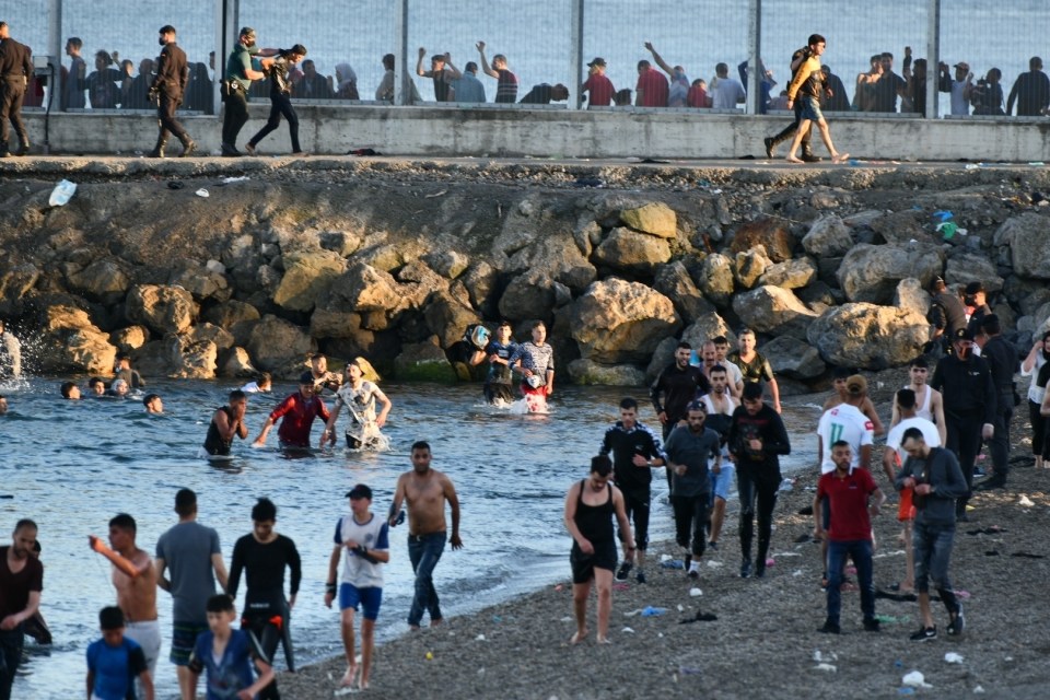 The migrants made their way along the beach once ashore in EU territory