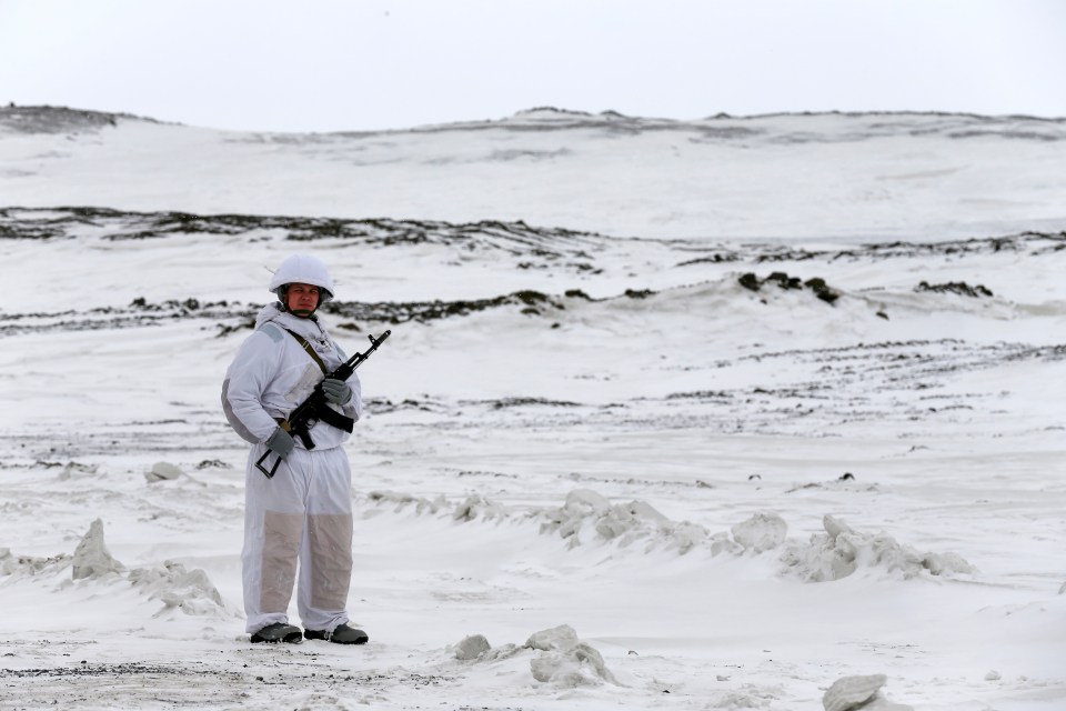 An armed soldier stands guard