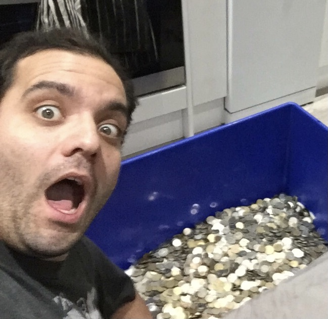 Jesse, 34, pictured with a large tub of spare change