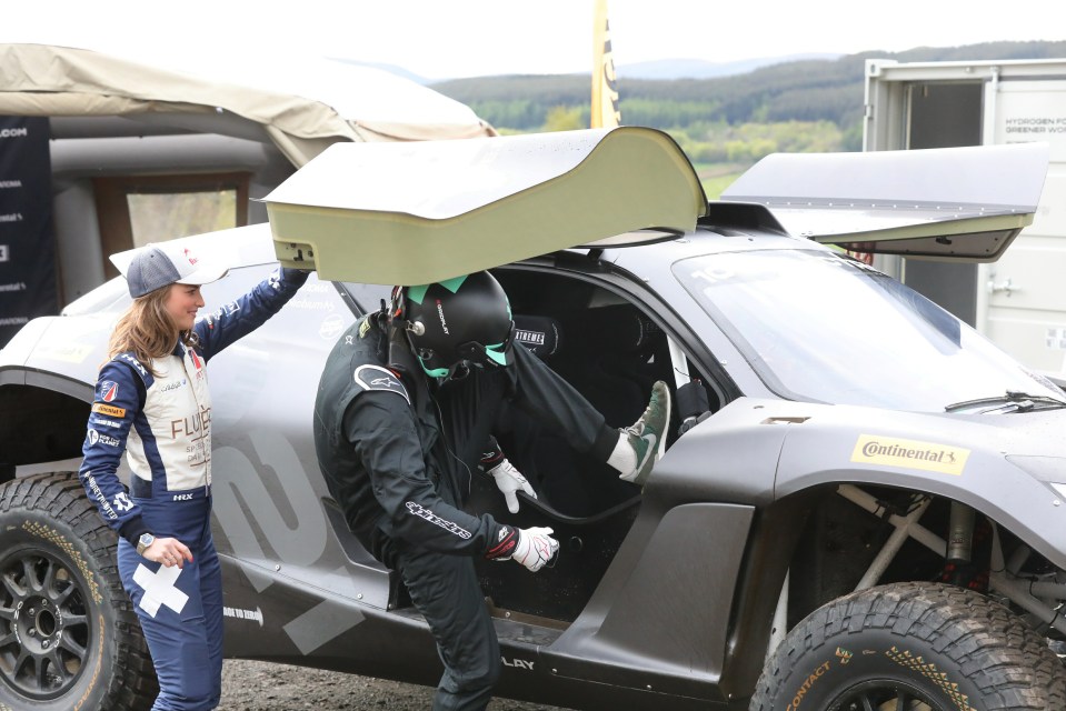 William climbs into the vehicle, helped by Cate