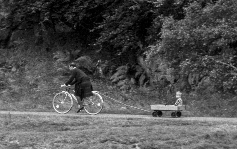 Prince Harry being towed by his dad at Balmoral Castle during a summer break