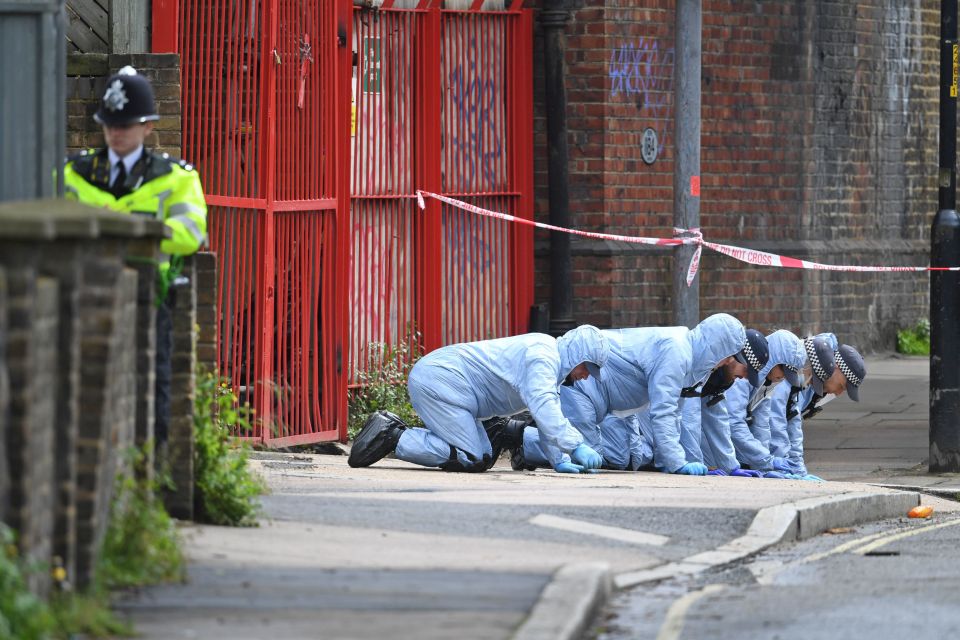 Forensic officers seen searching at the scene of the shooting