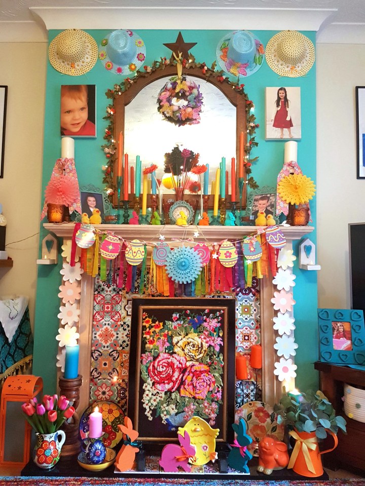  The fireplace is a hub of colour with candles, hats and decorations