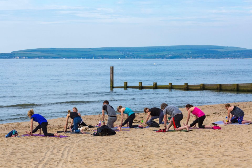 Brits enjoying a workout session on the beach as temperatures reach into the 20Cs