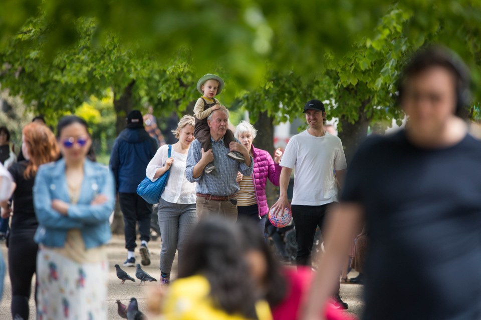 The public enjoy the sunny weather in Victoria Park, east London