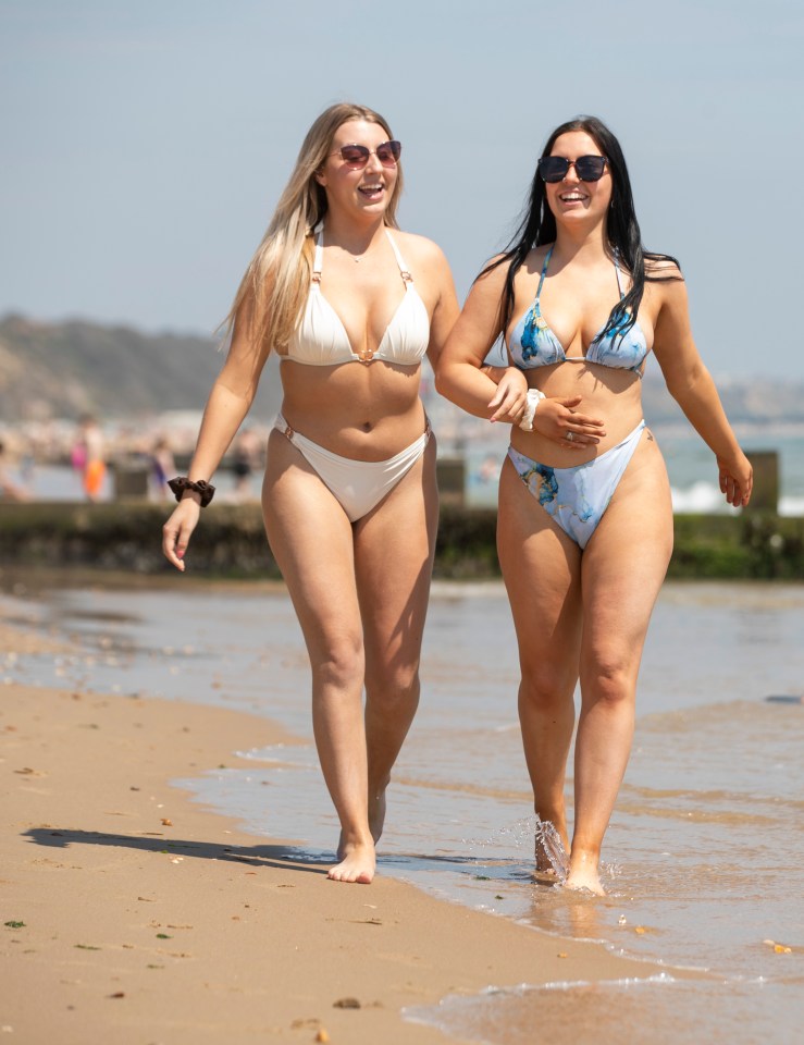 Two women, Caitie and Issy, enjoying a day trip to Bournemouth beach