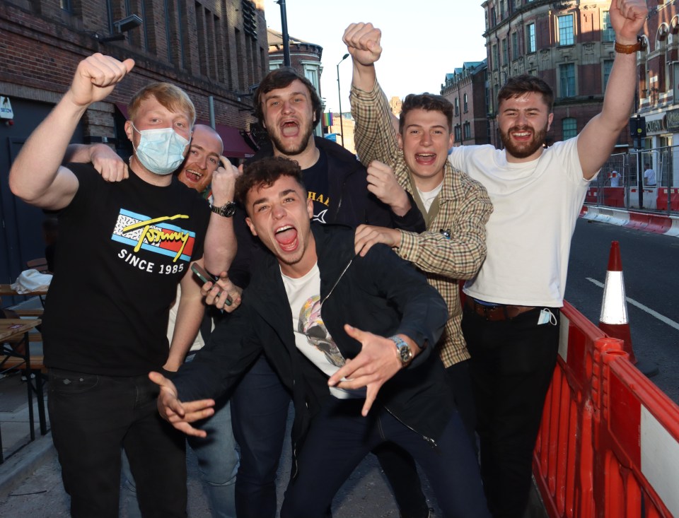 A group of men cheered for the camera as they enjoyed a night on the town