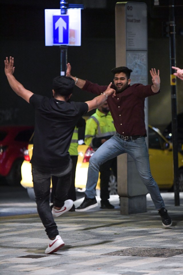 Two lads dancing in the street