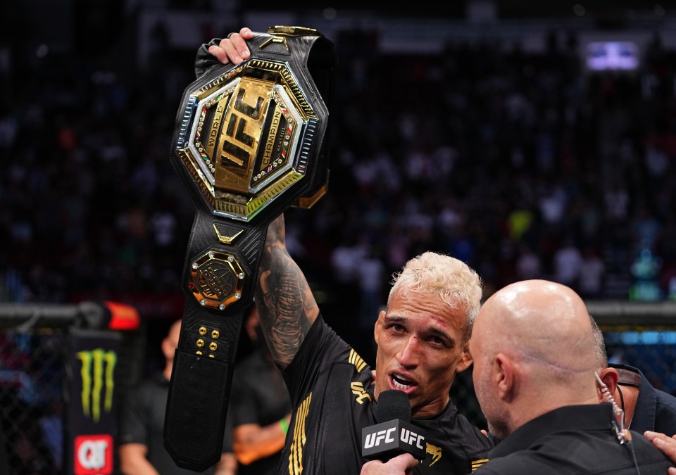 An emotional Charles Oliveira celebrates claiming the UFC lightweight title