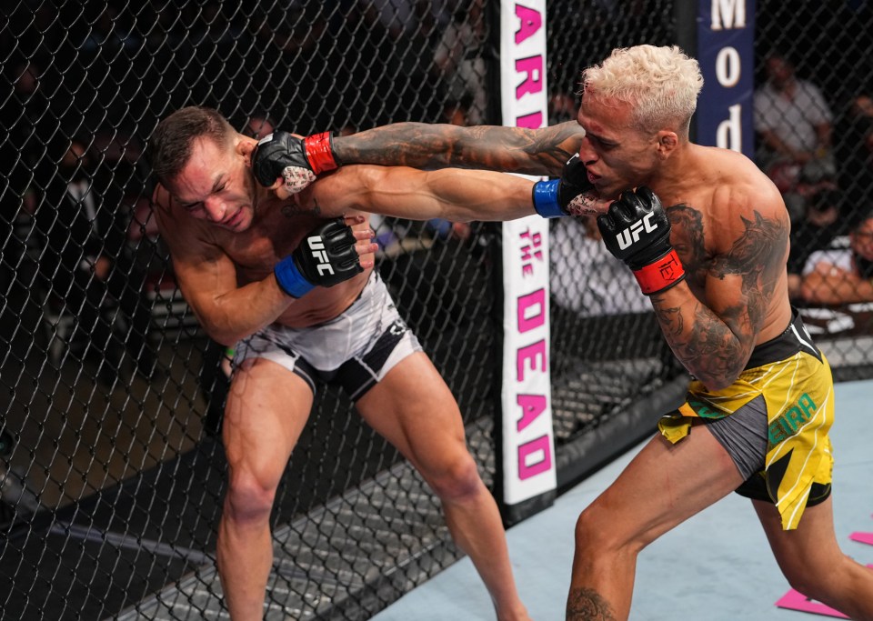 Charles Oliveira goes in the for the kill against Michael Chandler