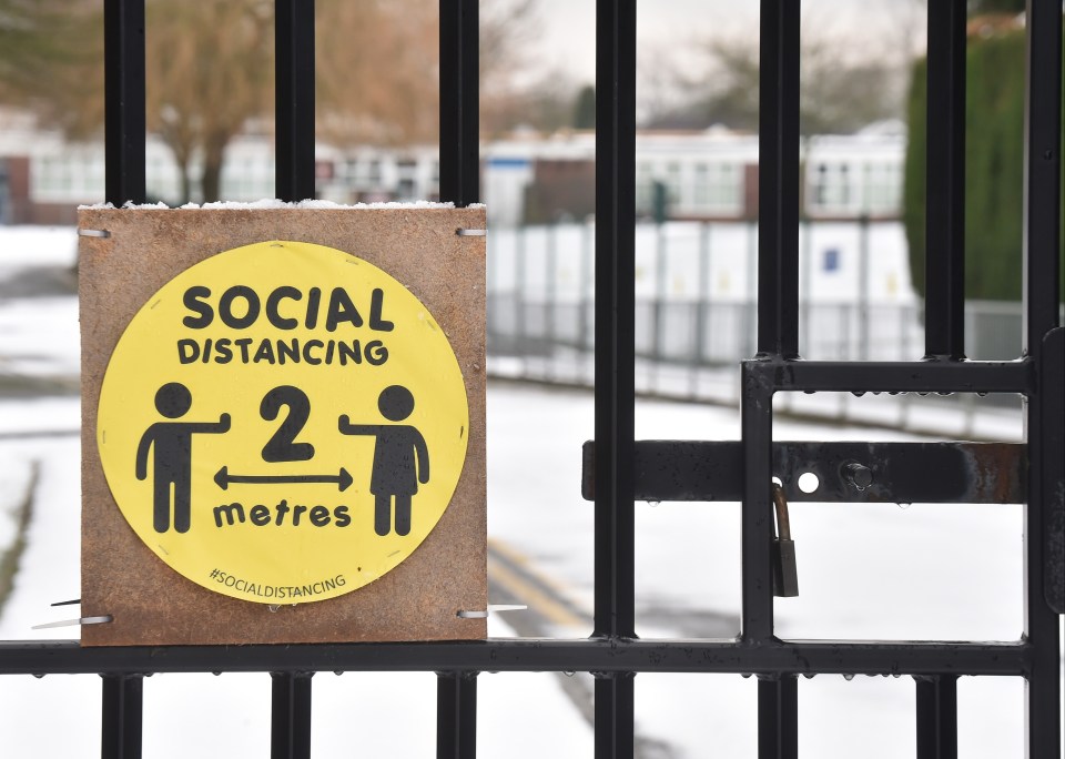 A social distancing sign displayed outside a primary school in Newcastle-Under-Lyme