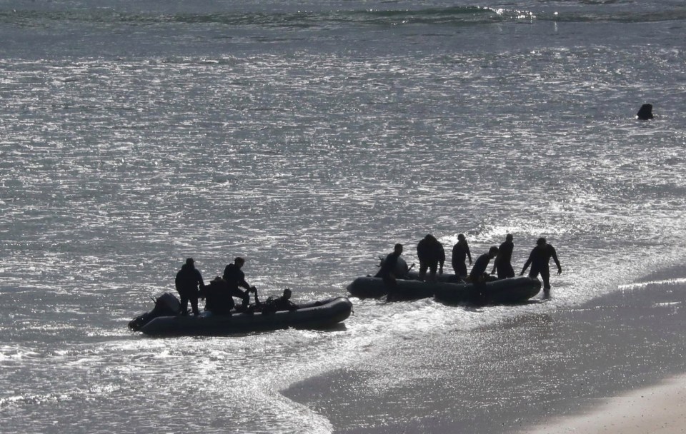 Personnel land on Carbis Bay beach from inflatables early on Tuesday morning