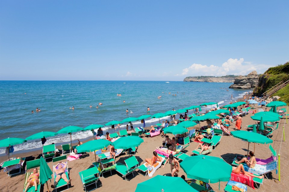 The NHS App offers a glimmer of hope for foreign holidays (Picture shows tourists on the beach on the Campania coast in Italy)