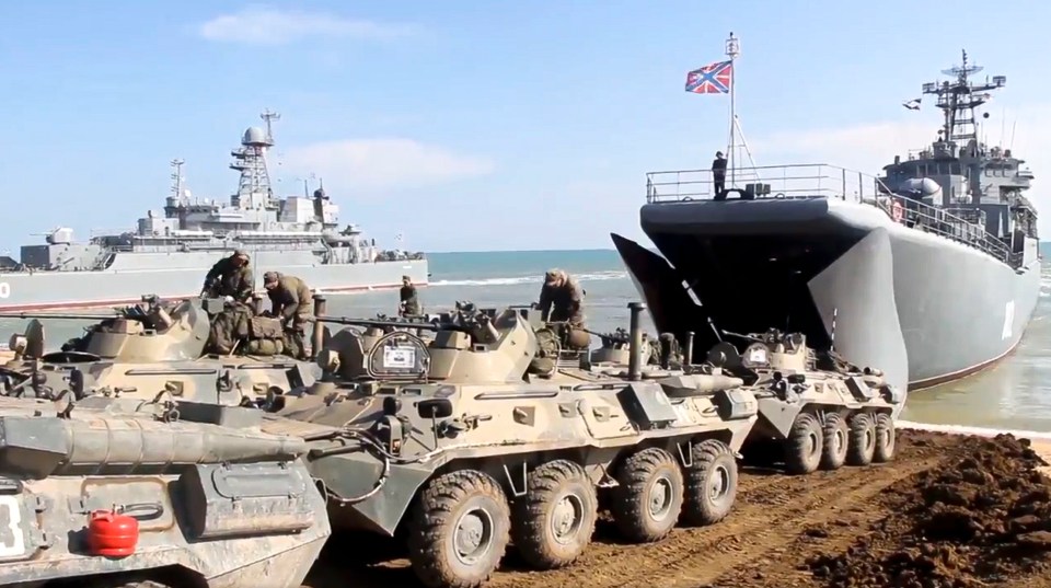 Russia's military vehicles roll onto landing vessels following military drills in Crimea